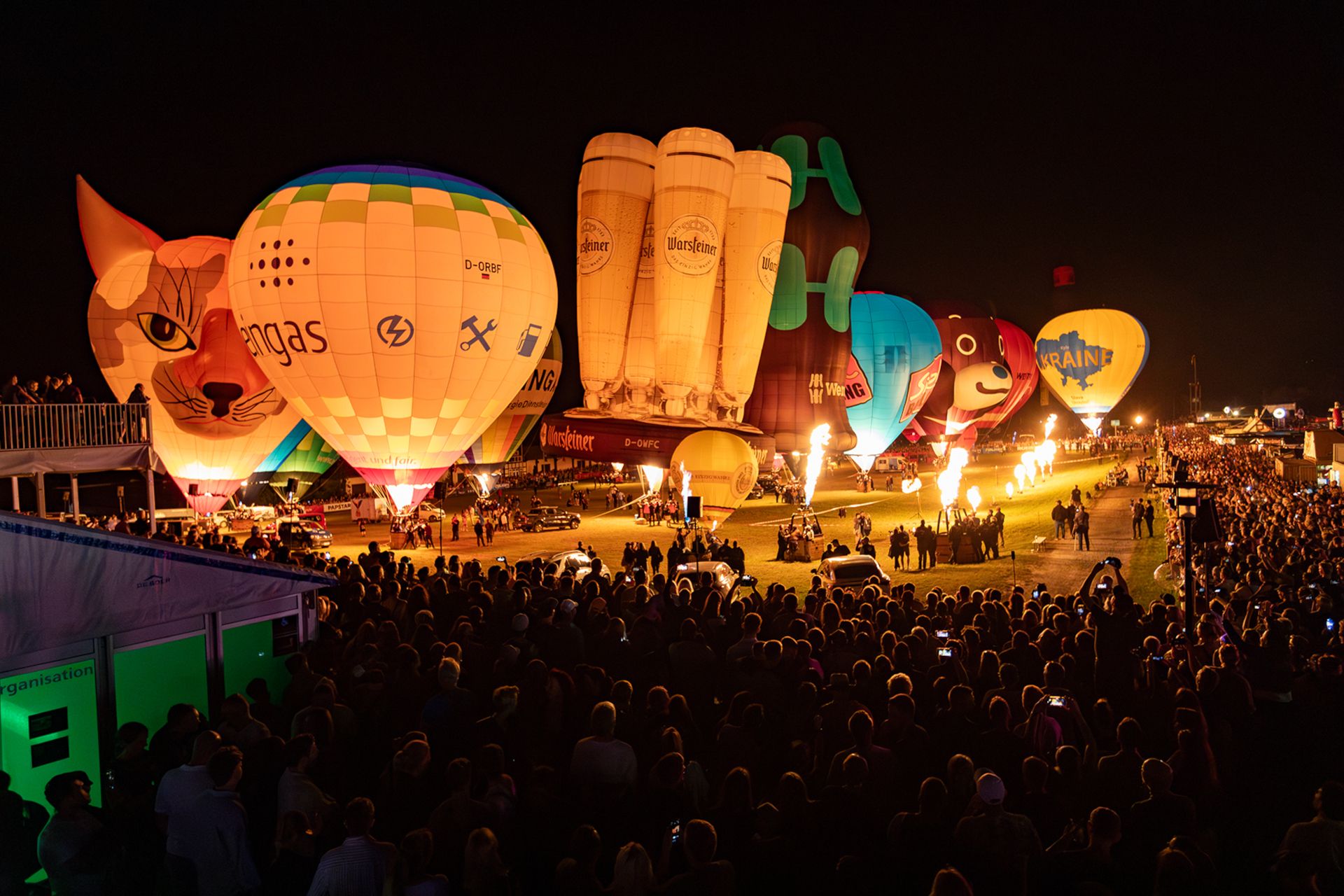 At Night-Glow, flames light up the beautiful hot-air balloons in the dark