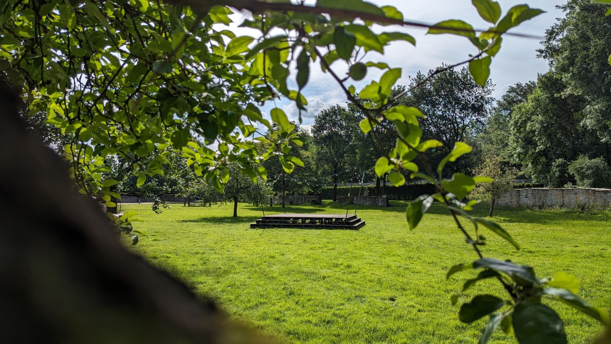 The Dancefloor artwork is an installation made of wood, iron bars and a framing chain of lights