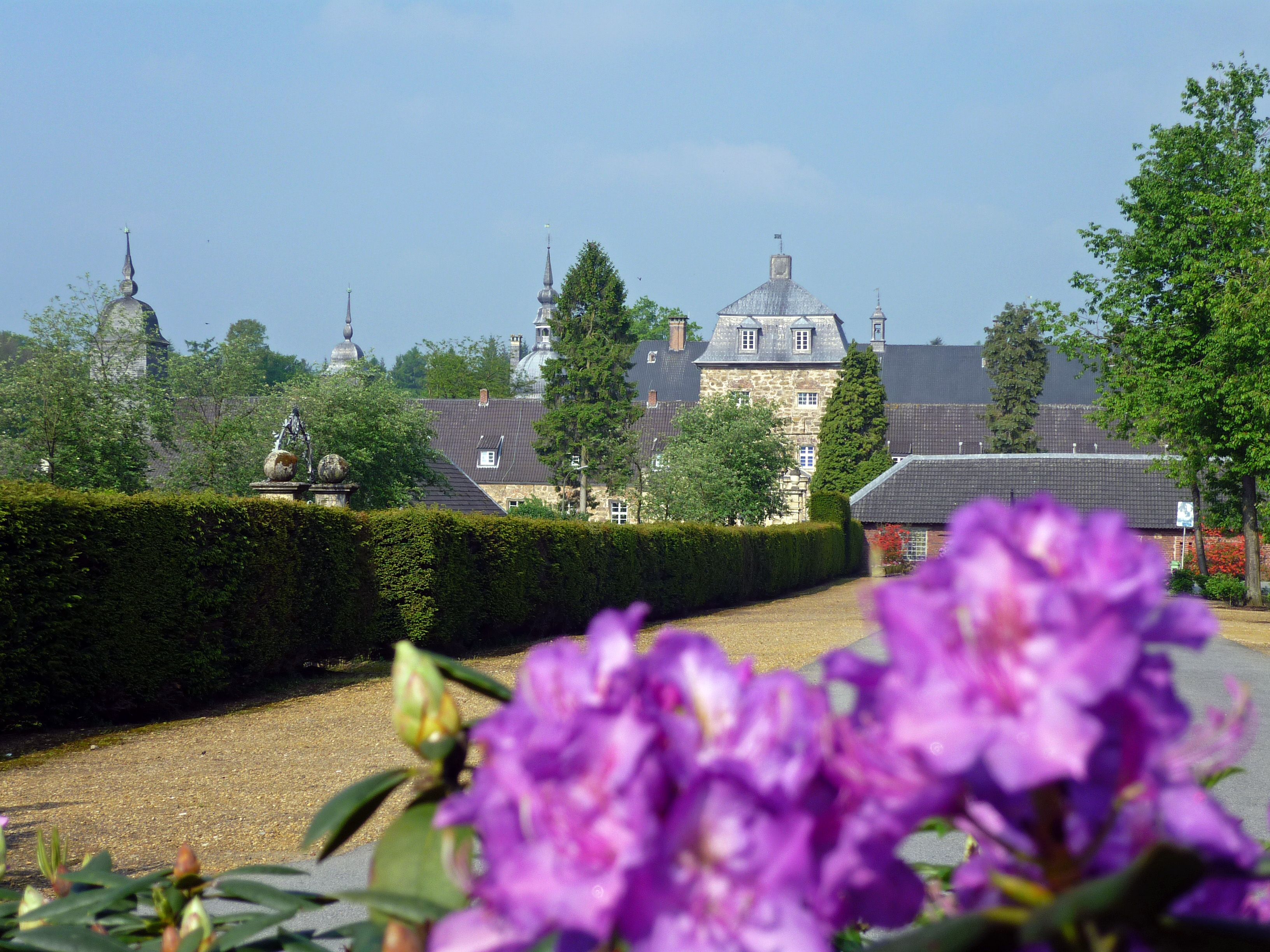 The splendor of flowers around the moated castle is impressive