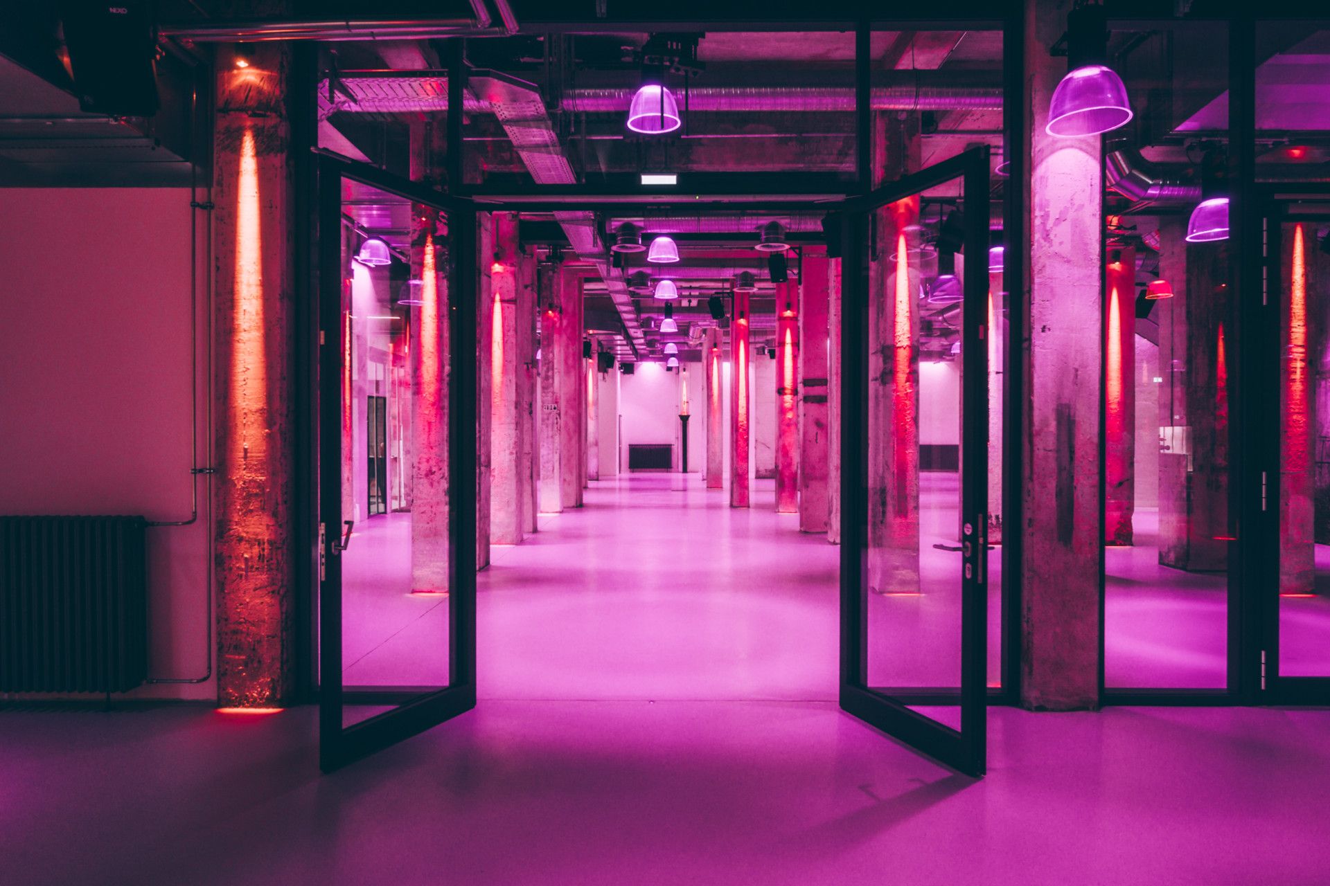 Purple illuminated foyer with open doors of the Grand Hall in the Tollverein colliery in Essen