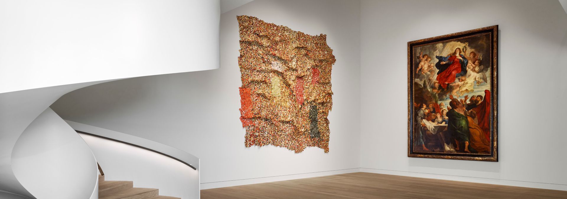 Peter Paul Rubens' Assumption of Mary hangs directly next to the work Earthcloth by the Ghanaian sculptor El Anatsui