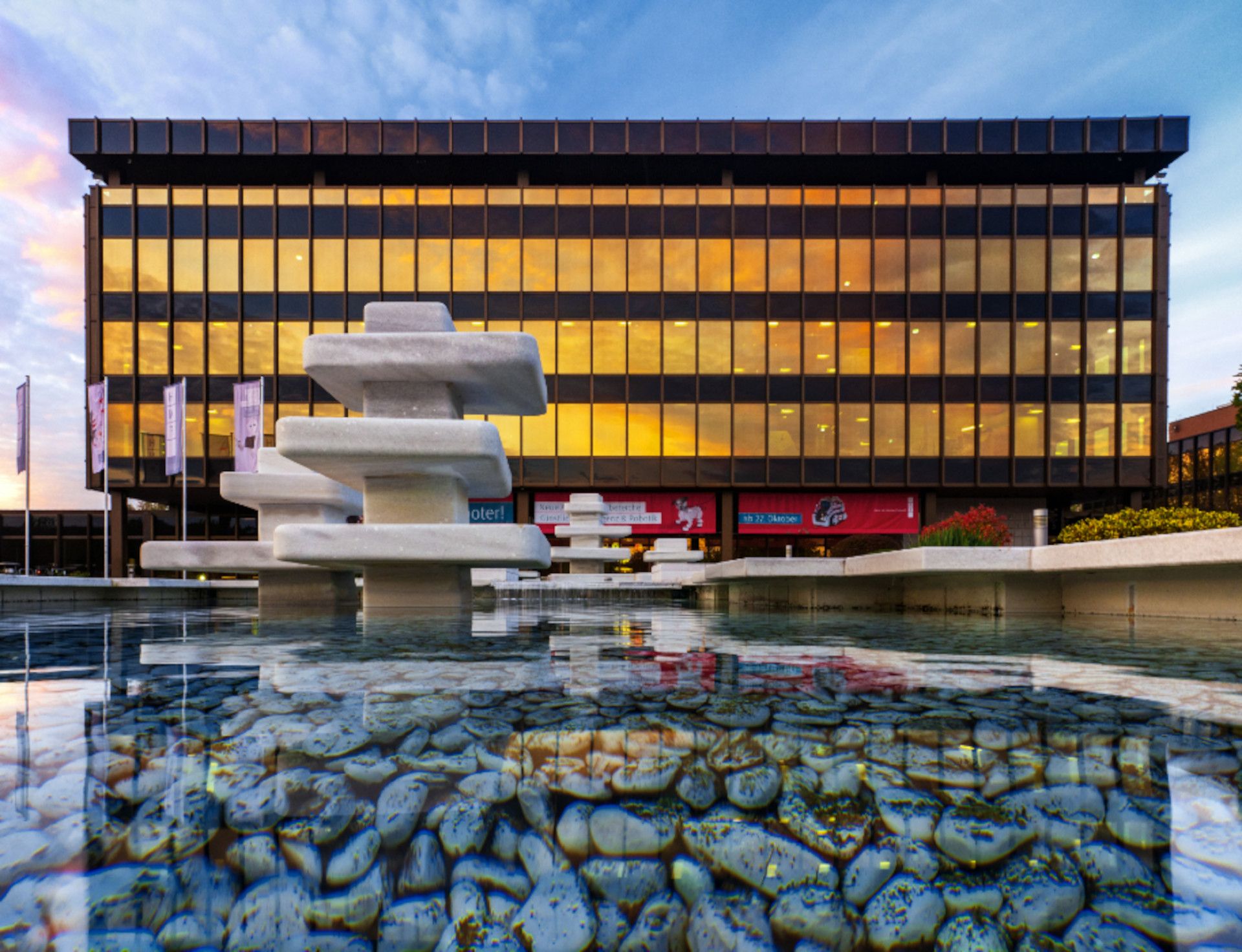 Facade of the HNF with pond in front of it