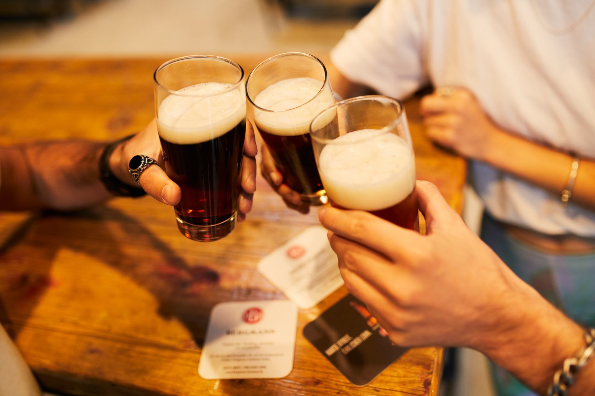 Beer glasses are held by hands